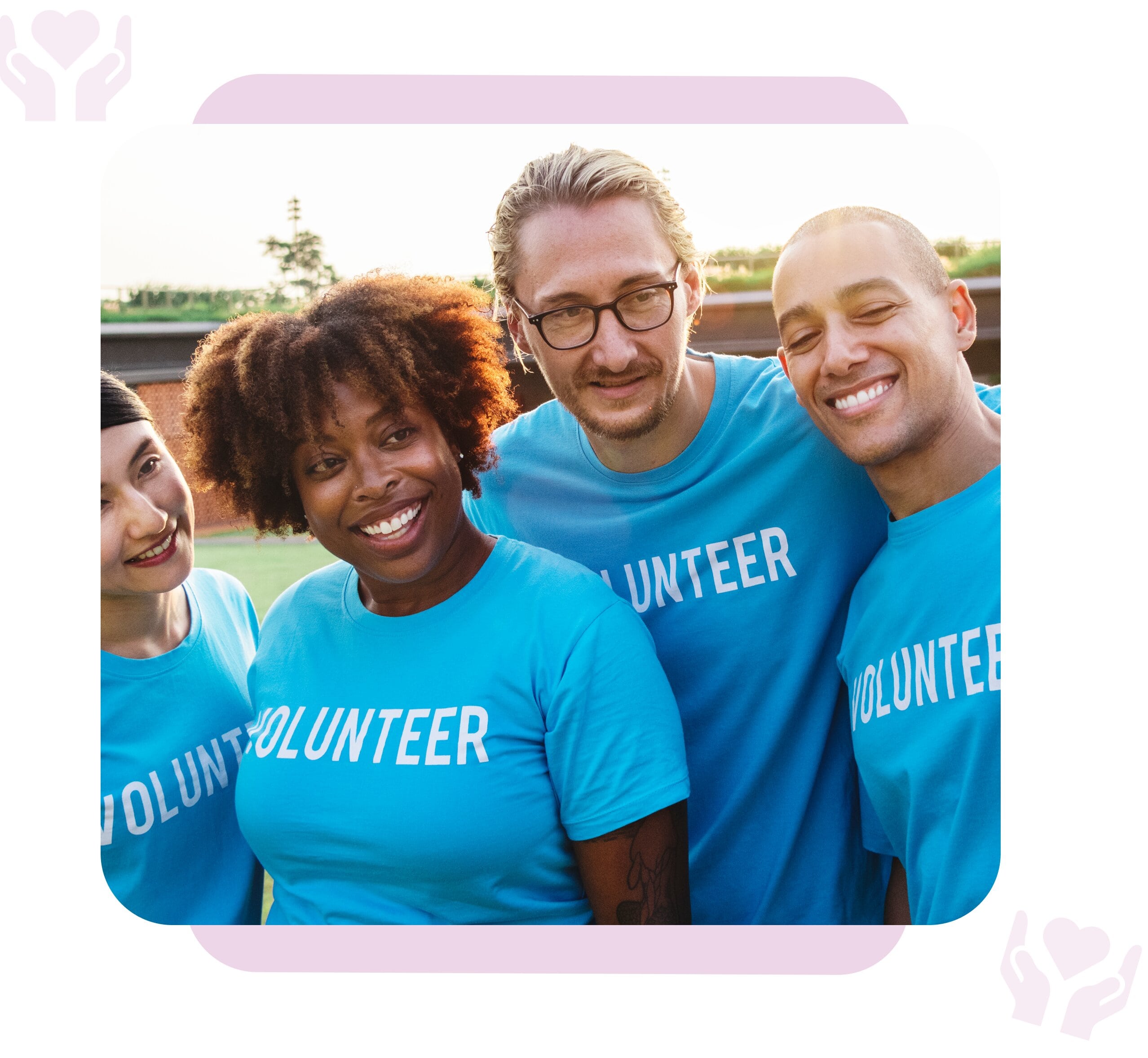 A group of smiling volunteers standing together, surrounded by heart and hand icons.